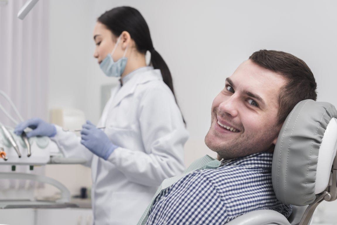 A patient at the chair with a clinician attending