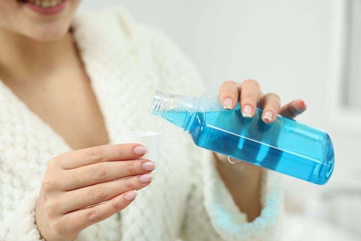 Mouthwash being poured into a cap